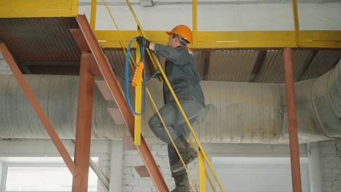 Construction or factory worker with safety gear climbs ladder stairs Stock Footage 272756166
