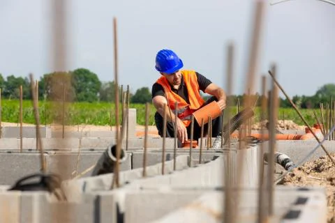 Construction or site manager checking or overseeing the foundations of the new Stock Photos