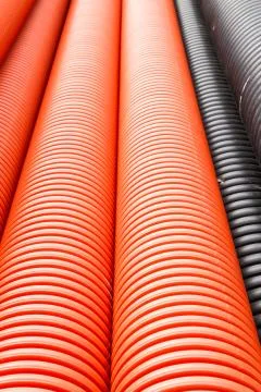 Construction orange and black plastic pipes Stock Photos