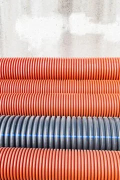 Construction orange and black plastic pipes Stock Photos