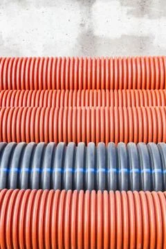 Construction orange and black plastic pipes Stock Photos