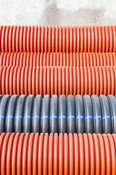 Construction orange and black plastic pipes Stock Photos