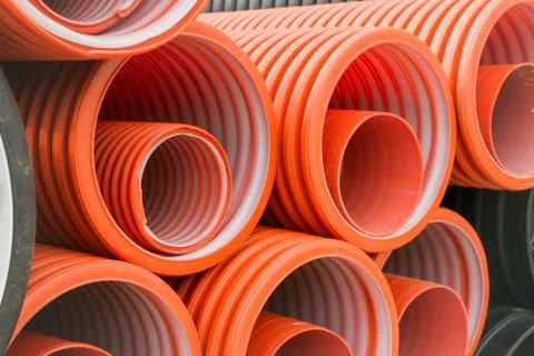 Construction orange and black plastic pipes Stock Photos