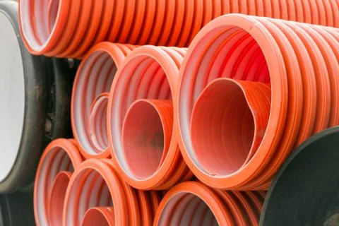 Construction orange and black plastic pipes Stock Photos