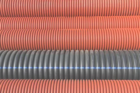 Construction orange and black plastic pipes Stock Photos