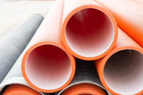 Construction orange and black plastic pipes Stock Photos