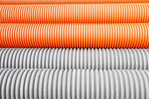 Construction orange and black plastic pipes Stock Photos