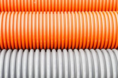 Construction orange and black plastic pipes Stock Photos