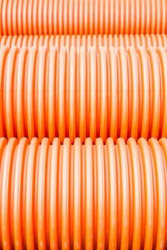 Construction orange and black plastic pipes Stock Photos