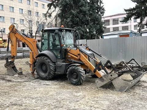 Construction Orange Excavator Standing At Construction Site On City Street .. Foto stock