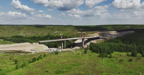 Construction of overpass highway bridge among forests 库存影片 257431290