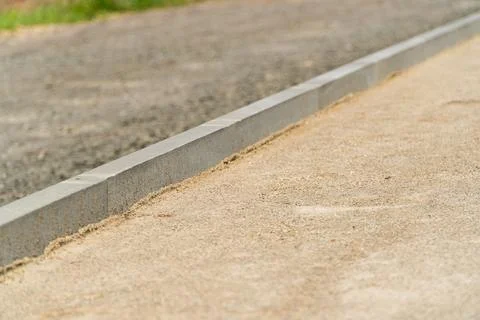 Construction of a pedestrian path. Laying the path with paving bricks. Фото
