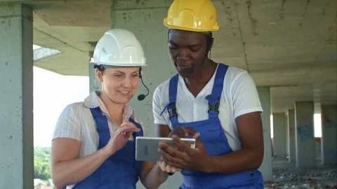 Construction people using electronic tablet on site Stock Footage 82803176
