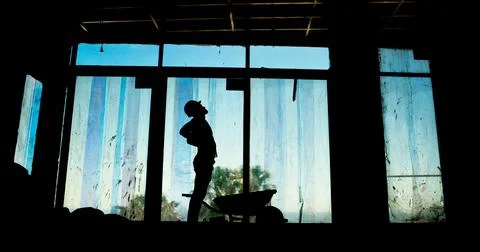 Construction, person and engineer with back pain, hurt and silhouette of Foto stock