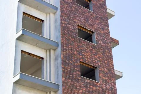 At construction phase brick wall facade design of empty building Foto stock