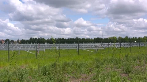 Construction phase of a ground-mounted solar park under a cloudy sky Stock Footage 130563294