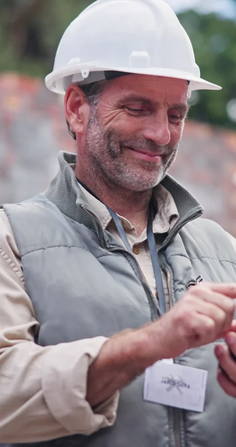 Construction, phone and mature man at site for building report, safety Stock Footage 340947545