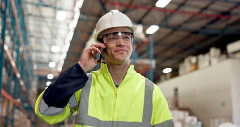Construction, phone call and worker in warehouse with PPE, conversation and Stock Footage 318506418