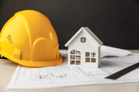 Construction plans with helmet and model of house Stock Photos