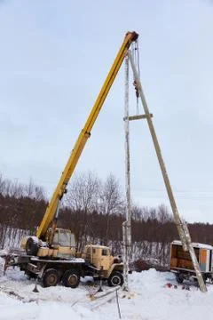 Construction of power lines using a mobile crane Stock Photos