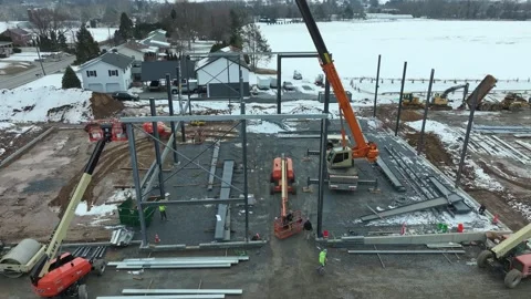 Construction Process of a Building in Winter With Cranes and Heavy Machinery Stock Footage 335652397