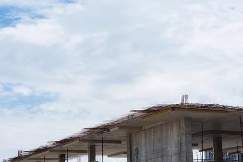 Construction process of a concrete building with exposed rebar and supporting Stock Photos