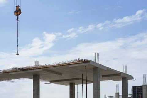 Construction process of a concrete building with exposed rebar and supporting Stock Photos