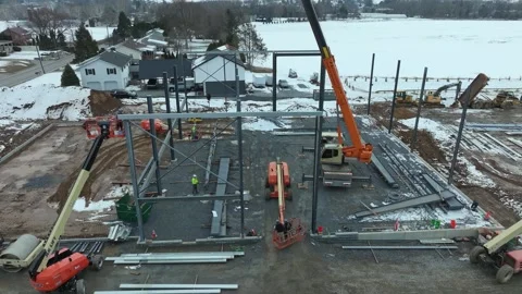 Construction Process of a Large Building Near a Lake in Winter Months Stock Footage 335652320