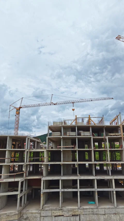 Construction process of a multi-storey building with cranes working on the site Stock Footage 337902660