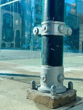 Construction process shown through metal pole with glass panels on a city s.. Stock Photos