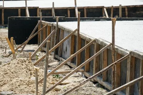 Construction Process Shows Wood Framing and Sand Near New Concrete Slab in .. Stock Photos
