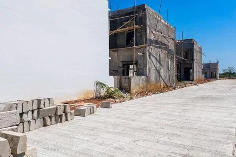 The construction process of a two-story house structure with scaffolding in.. Stock Photos