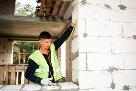 Construction professional installs insulation, wall treatment, teamwork, bu.. Stock Photos