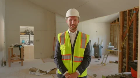 A Construction Professional Wearing a Hard Hat and Safety Vest Working on a Job Vídeo Stock 308699017