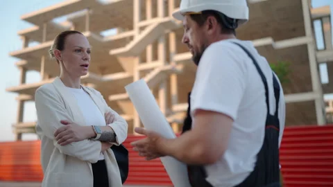Construction professionals reviewing architectural plans with a female clie.. Stock Footage 341333127