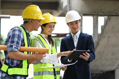 Construction professionals team using digital tablet and discussing about 스톡 사진