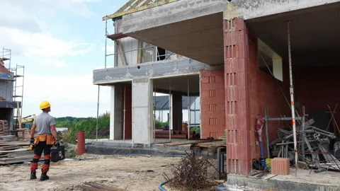 Construction Progress at a Building Site in Warm Weather, Showcasing Structural Stock Footage 314004545