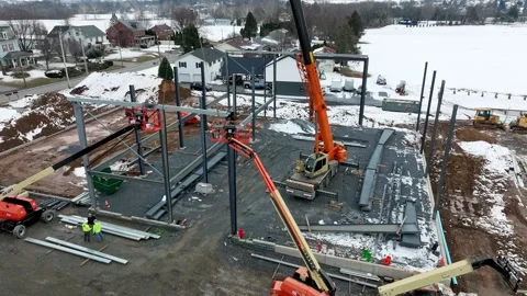Construction Progress of a Building in Winter With Cranes and Workers on Site Stock Footage 337642338