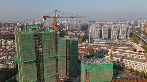 Construction progress of buildings in Hangzhou, China during daytime, showing Stock Footage 324699598