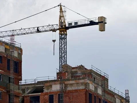 Construction In Progress, Elevating Structure With Crane Amidst Scaffolding And Stock Photos
