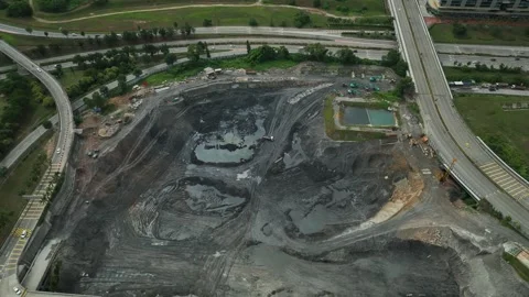 Construction progress on land development project near highway in urban area Stock Footage 311987211