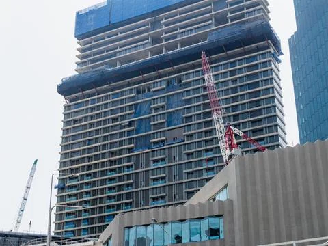 Construction progress modern high-rise building in urban cityscape daytime .. Stockfoto's