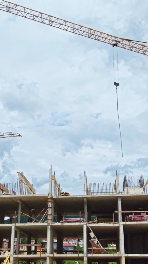 Construction progress of a multi-storey building with cranes and scaffolding Stock Footage 337912012