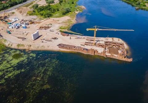 Construction progress of a new modern bridge building. Aerial drone view Фото