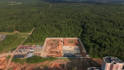 Construction in Progress: Preparing Foundations Next to Woodlands Stock Footage 257772819