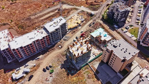 Construction progress of residential buildings in a developing area during a Vídeos de archivo 346062290