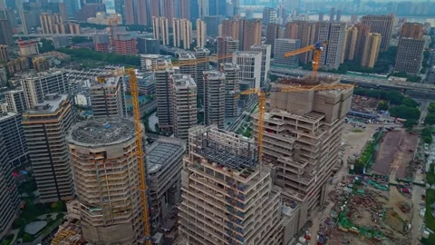 Construction progress of a skyscraper in a bustling urban area during sunset Stock Footage 311844191