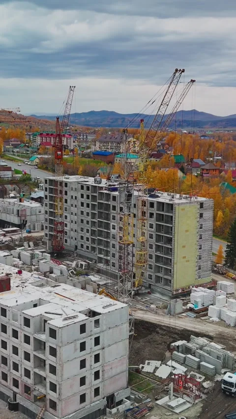 Construction progresses on apartment buildings in a developing neighborhood Stock Footage 308952441