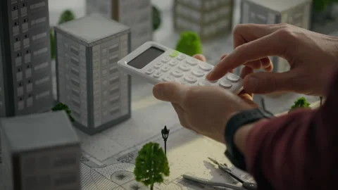 Construction. A project architect uses a calculator to make calculations in Stock Footage 269232313
