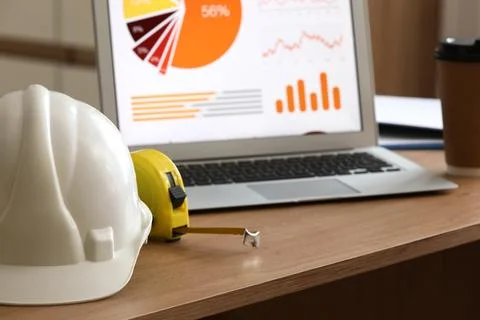 Construction project management and data analysis with hard hat, measuring ta Stock Photos
